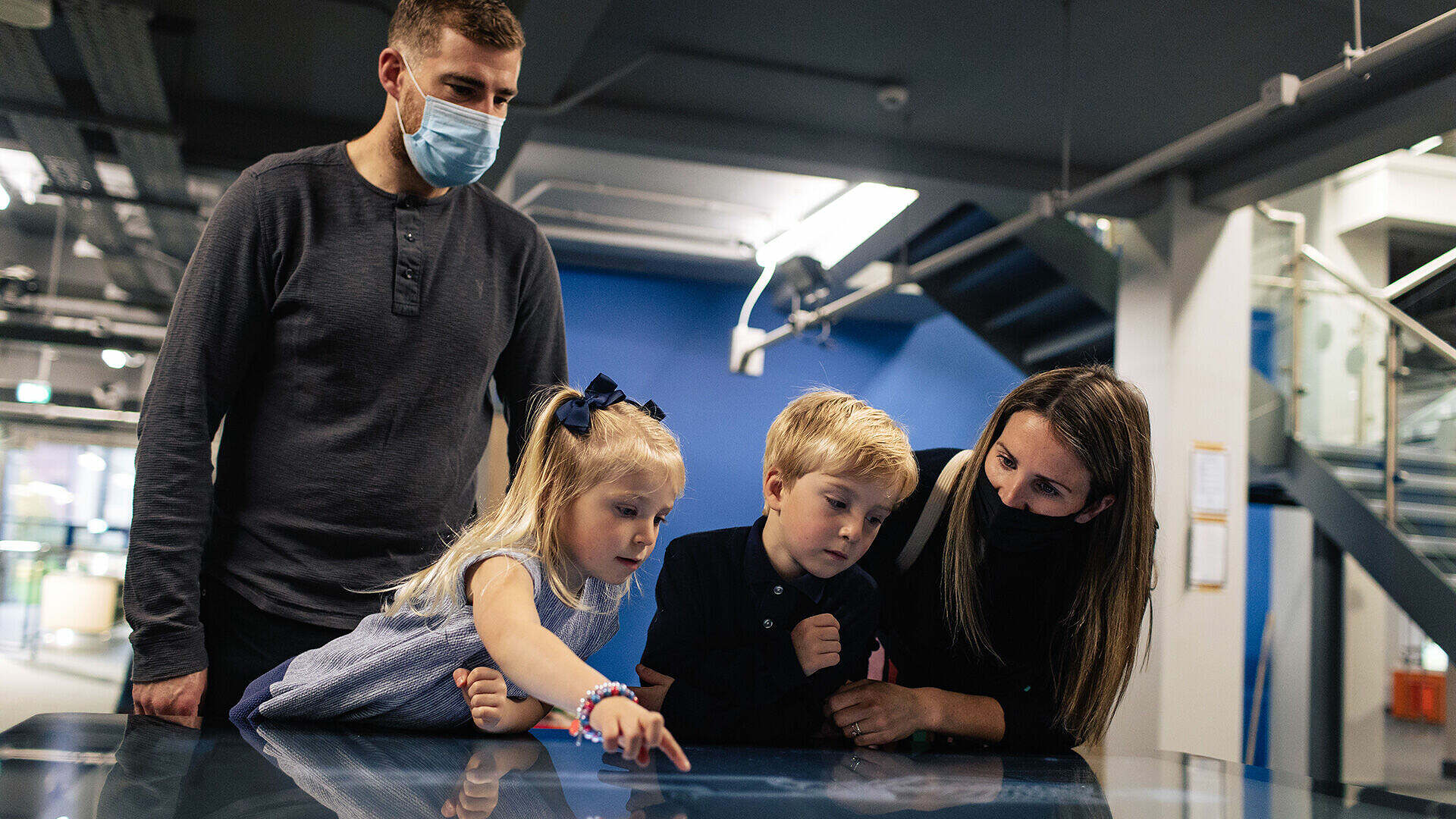 A family is learning anatomy using Inside Explorer installed on a multi touch table at The Aberdeen Science Centre.